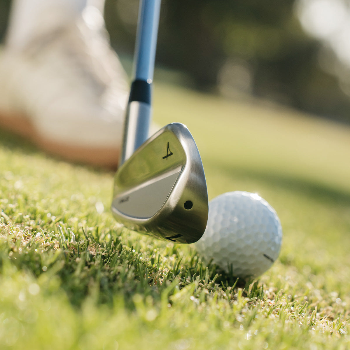 Takomo 101 MKII iron addressing a golf ball on course